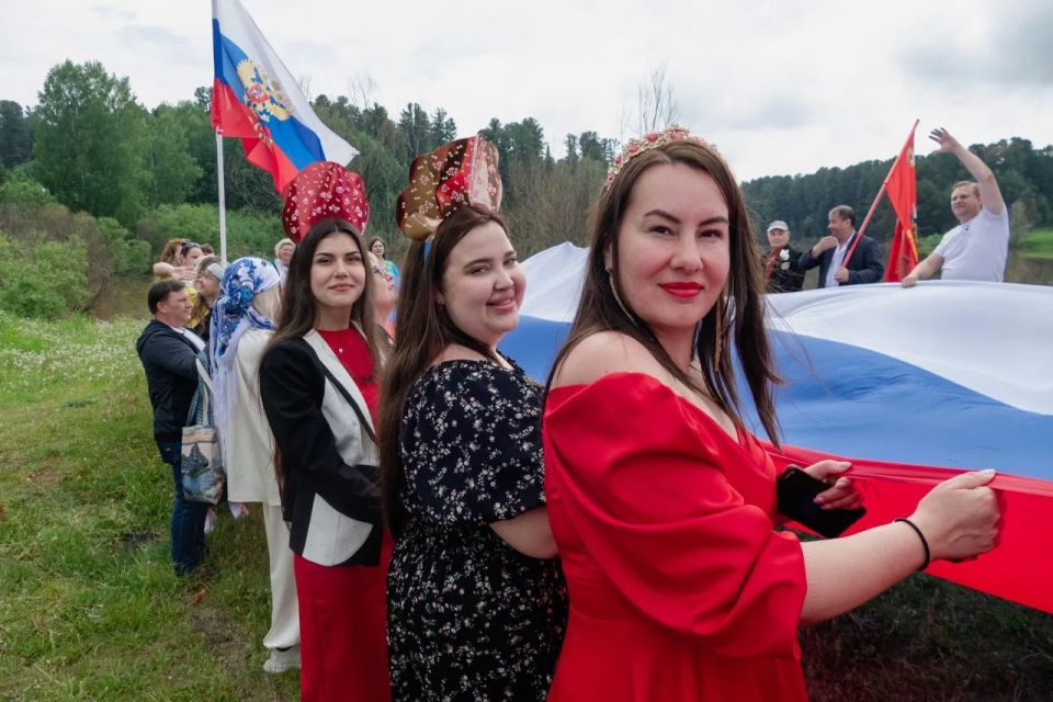 Участники автопробега ко Дню России развернули российский триколор в деревне Губино Участники автопробега ко Дню России развернули российский триколор в деревне Губино
